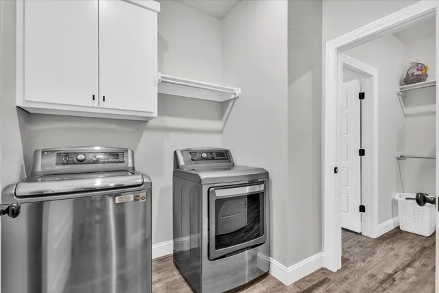 a kitchen with stainless steel appliances granite countertop a stove a refrigerator and a cabinets