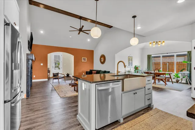a kitchen with stainless steel appliances granite countertop a stove and a refrigerator