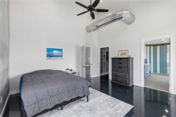 a living room with a bed furniture and a wooden floor