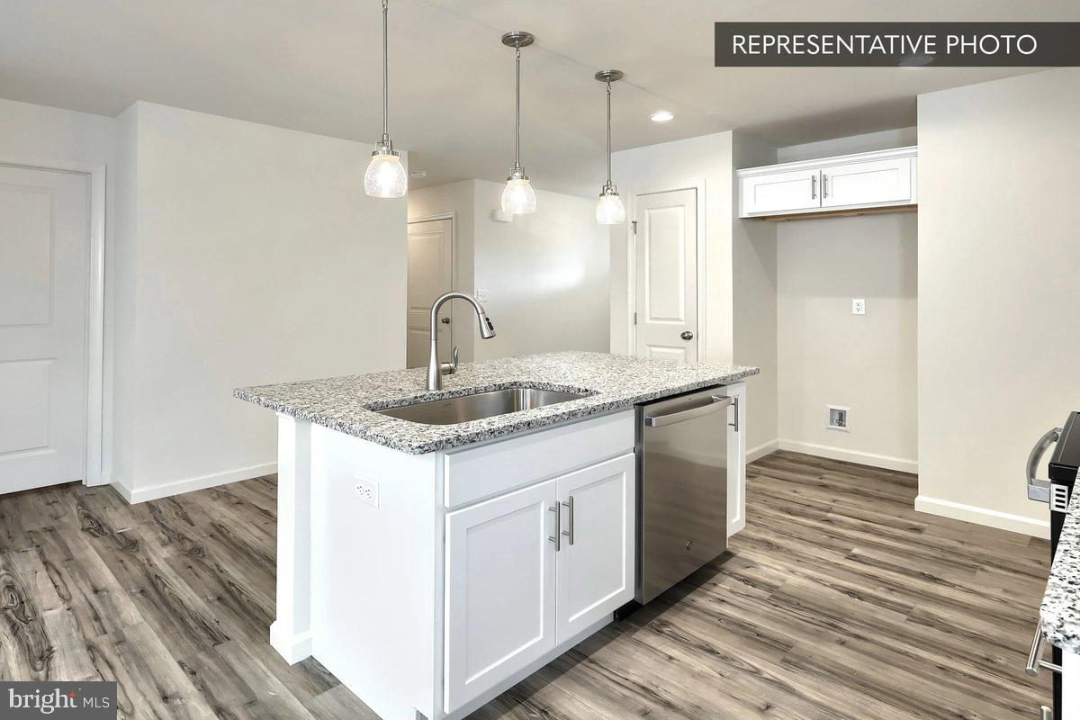 Sugar Maple Plan At Hills Spring Grove, PA 17362 - Photo 13 of 34 a kitchen with a sink cabinets and wooden floor