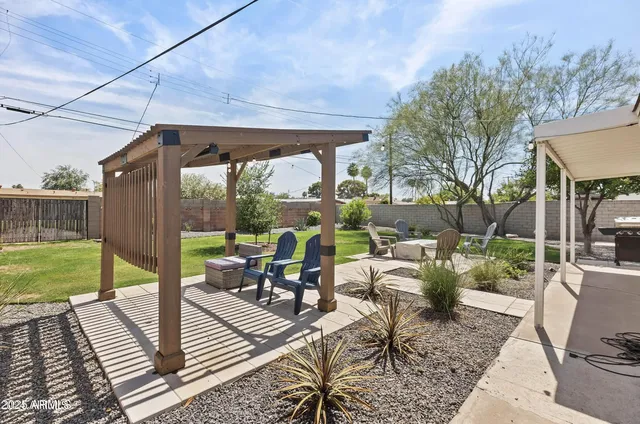 a view of a patio with couches chairs and city view