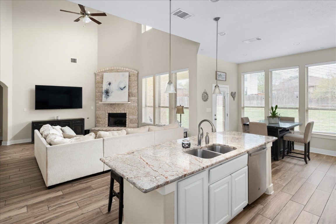 a kitchen with granite countertop a sink appliances and cabinets
