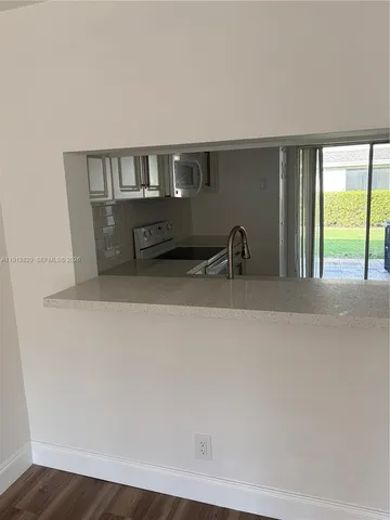a kitchen with a sink and large window
