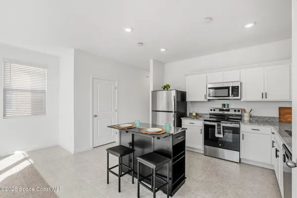a kitchen with a sink stainless steel appliances and cabinets