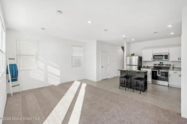 a view of kitchen with furniture and windows