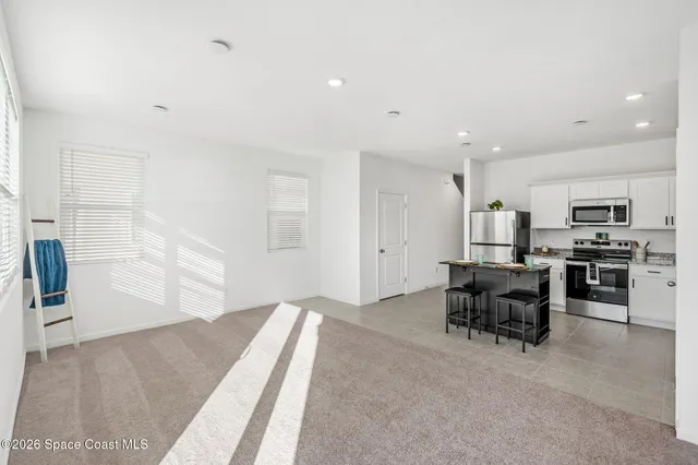 a view of kitchen with furniture and windows