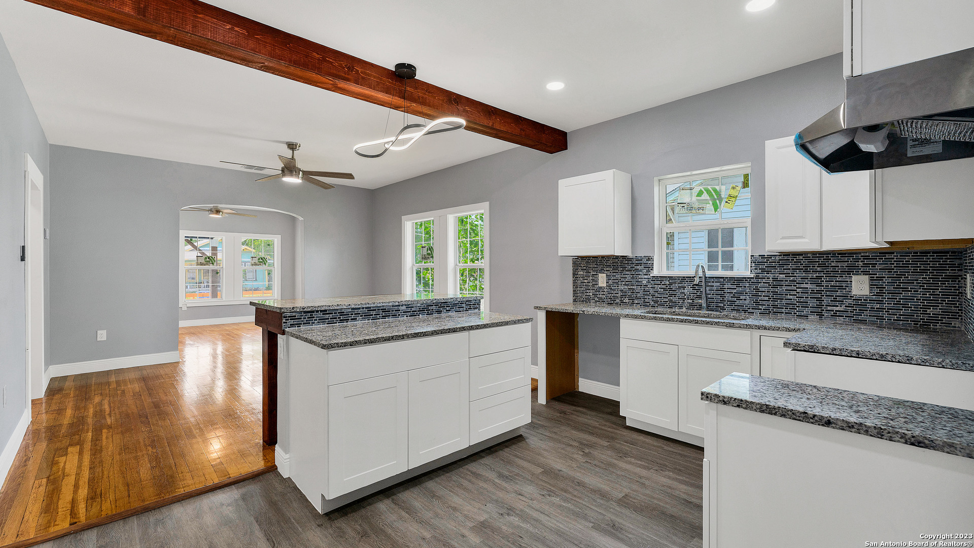 a large kitchen with granite countertop a stove and a sink