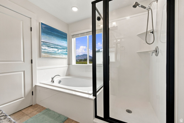 1566 Silver Canoe Loop Logan, UT 84321 - Photo 27 of 44 Built-in soaking tub with chrome fixtures, enclosed shower with matte black frame, tile flooring, and recessed lighting