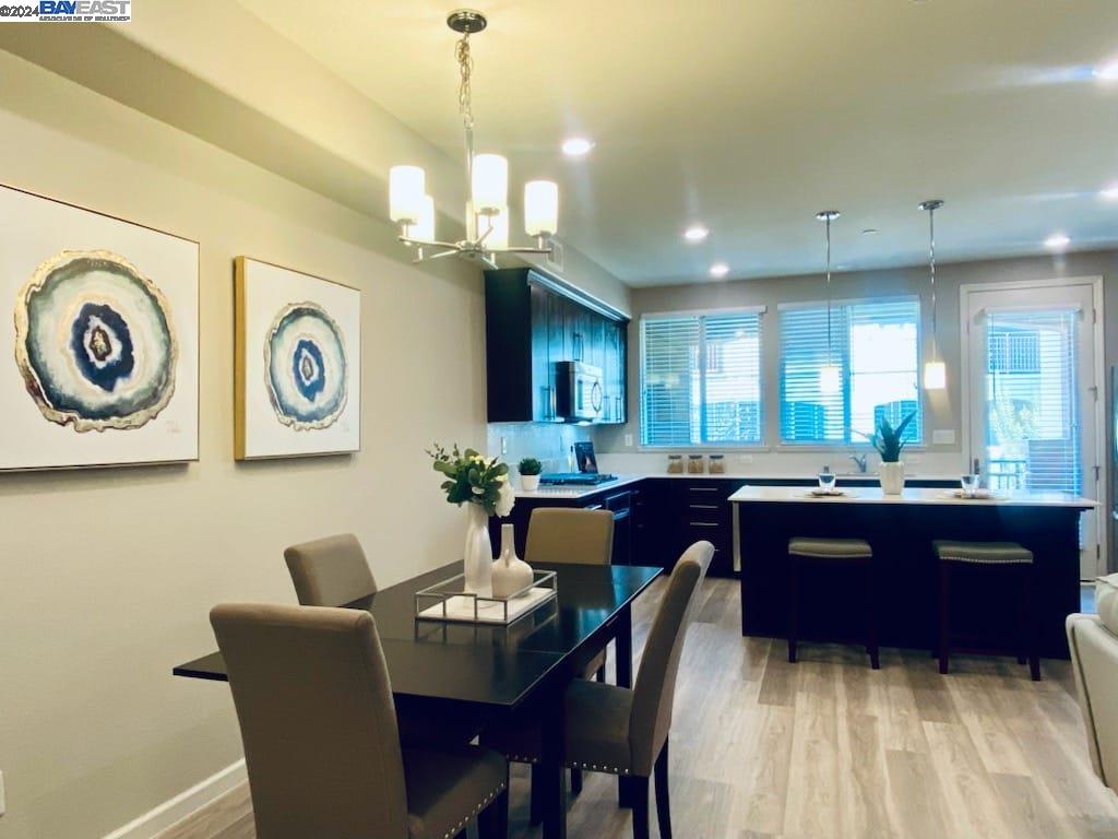 4724 Norris Canyon Road, Unit 102 San Ramon, CA 94583 - Photo 1 of 1 a living room with couches a dining table chairs and kitchen view
