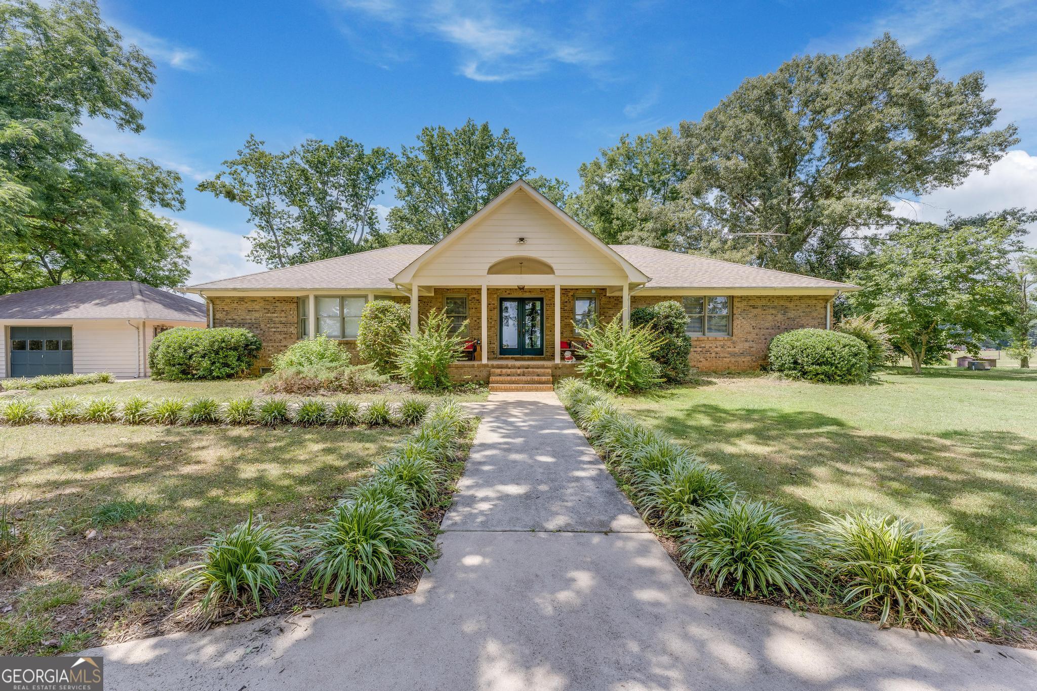 5454 Wildcat Bridge Road Royston, GA 30662 - Photo 1 of 1 a front view of a house with a garden