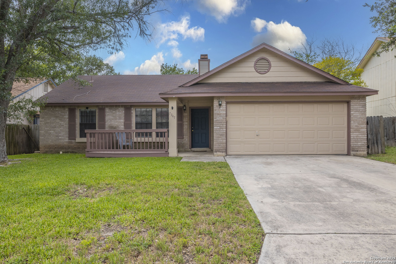 a front view of a house with a garden and yard