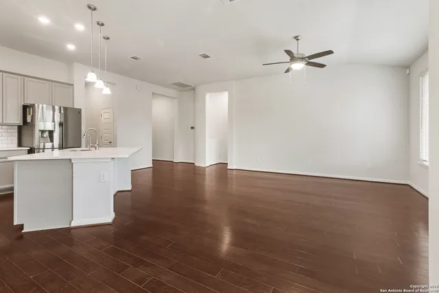 a view of a kitchen with cabinets and stainless steel appliances