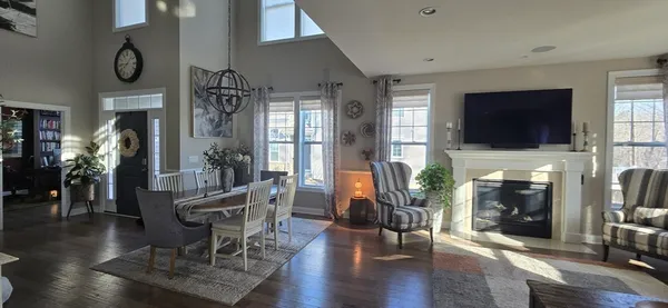 a kitchen with stainless steel appliances granite countertop a kitchen island a stove a table and chairs