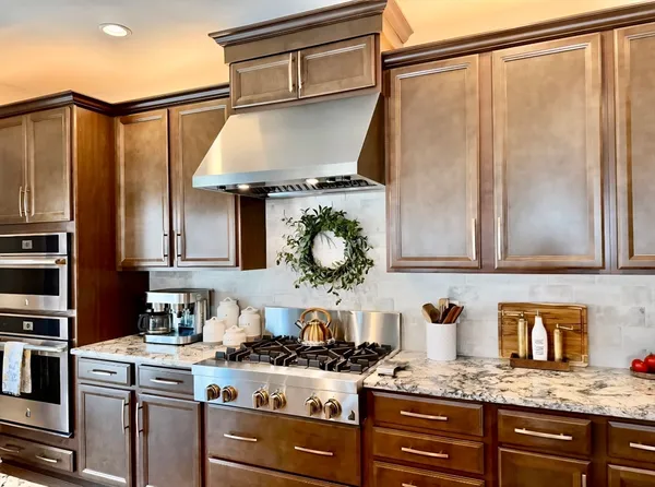 a bathroom with a granite countertop double vanity sink and mirror