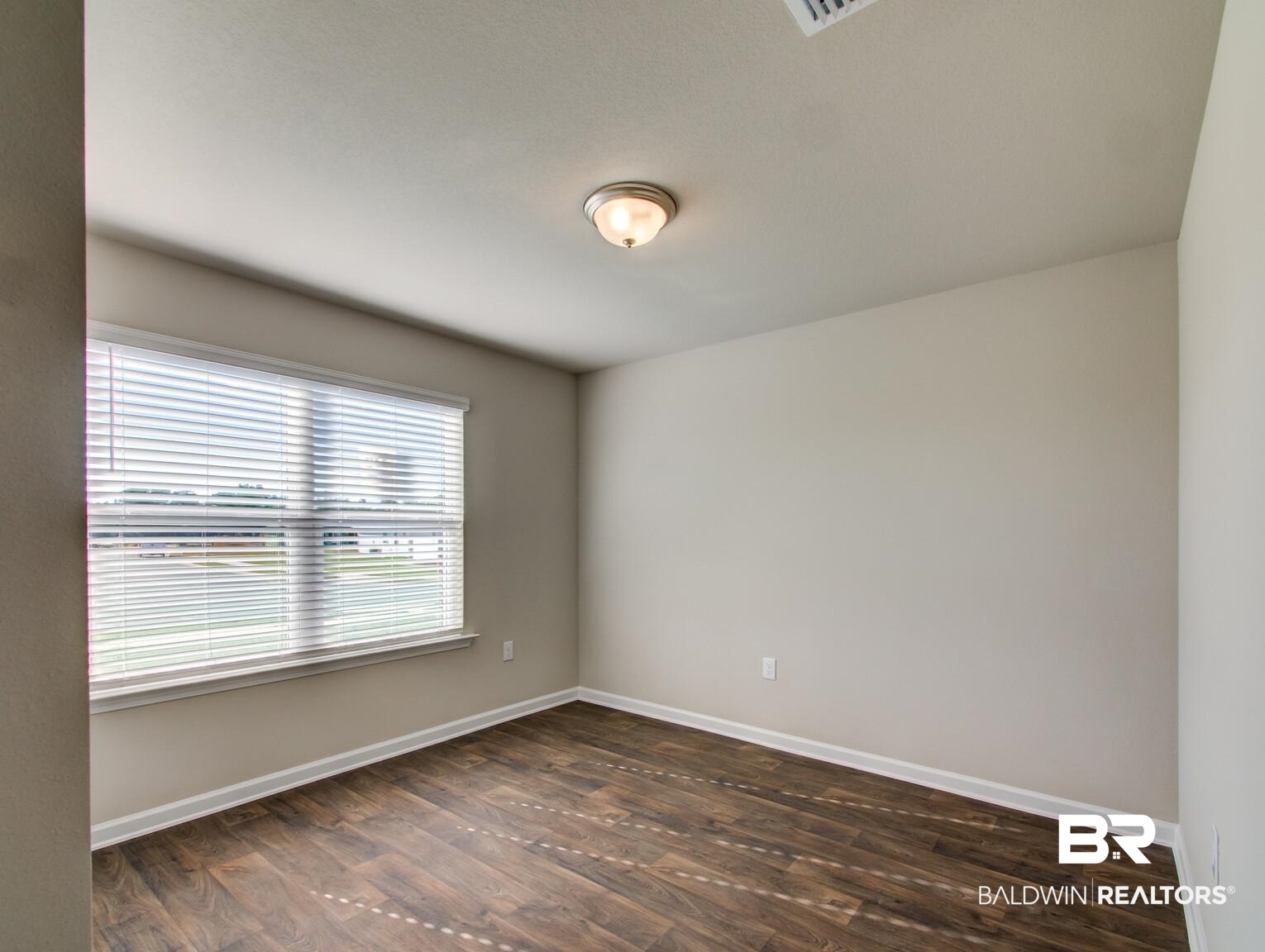 23952 Citation Loop Daphne, AL 36526 - Photo 31 of 69 Unfurnished room with baseboards and dark wood-style flooring