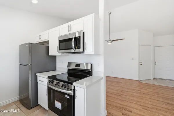 a kitchen with a stove a sink and a refrigerator