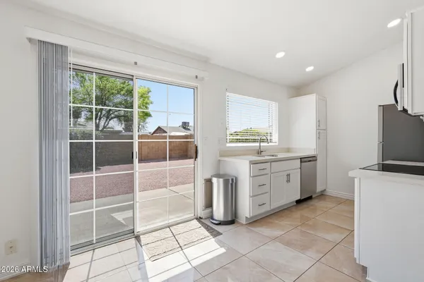 a kitchen with stainless steel appliances granite countertop a sink and a microwave