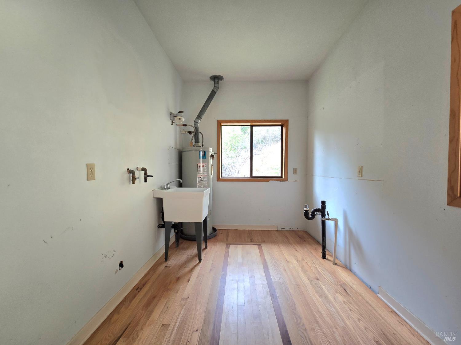 36955 Eureka Stagecoach Road Willits, CA 95490 - Photo 24 of 46 a view of a room with wooden floor white walls and a window