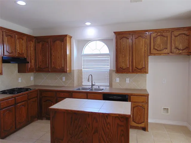 a front view of a house with a garden and plants