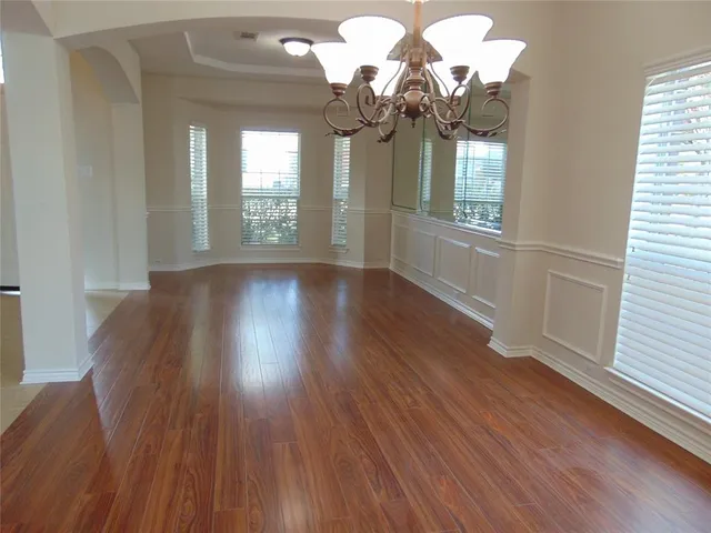 an empty room with a empty space and windows