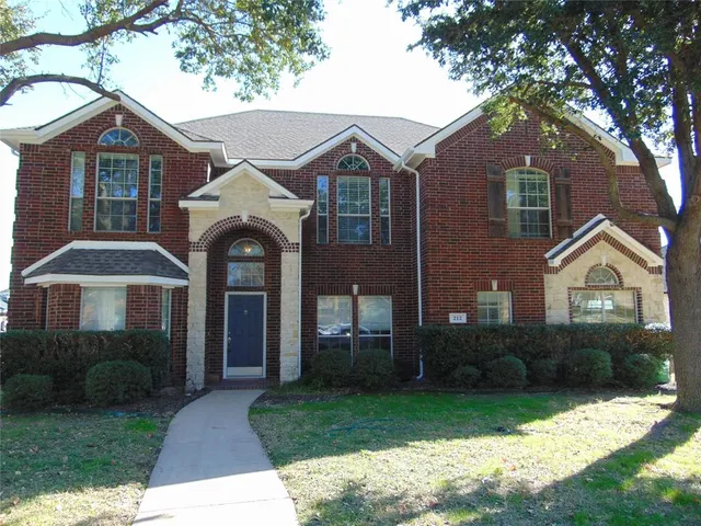 a view of a house with a yard and sitting area