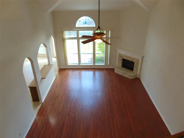 a kitchen with granite countertop a sink and a stove top oven with wooden cabinets
