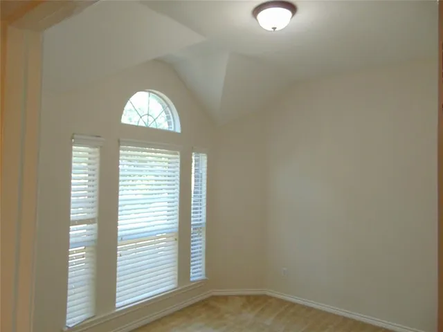 a view of a room with wooden floor