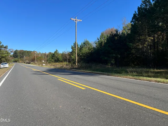 a view of a yard with an empty space and a lake view
