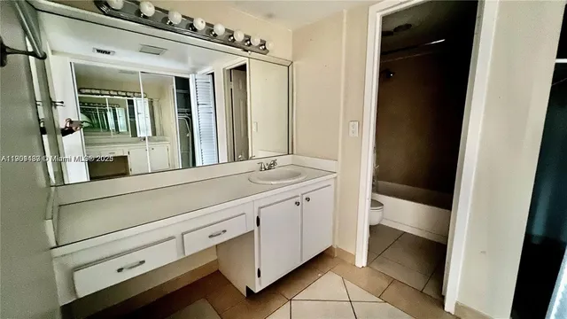 a bathroom with a double vanity sink and mirror