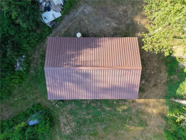 a backyard of a house with lots of green space and tree