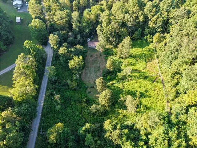 a bedroom with furniture and a large window