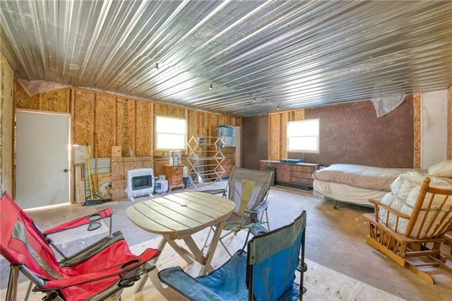 a spacious bedroom with a bed and a window