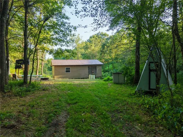 a view of a house with a backyard
