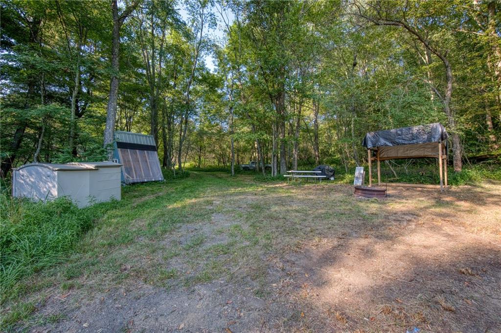 0 North Loop Road Dayton, PA 16222 - Photo 43 of 50 a view of a backyard with table and chairs a barbeque and a large tree