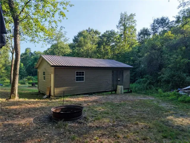 a backyard of a house with barbeque oven