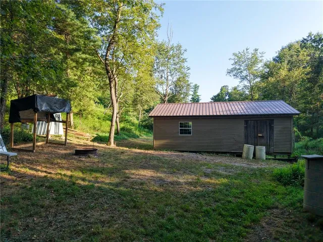 a backyard of a house with table and chairs