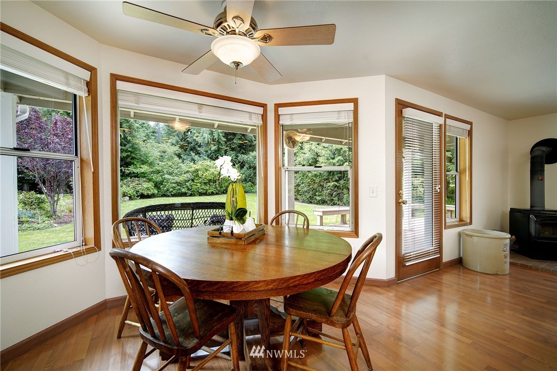 4826 200th Street Southeast Bothell, WA 98012 - Photo 14 of 40 a dining room with furniture window and wooden floor