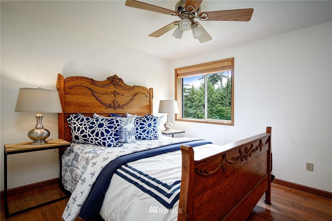 4826 200th Street Southeast Bothell, WA 98012 - Photo 29 of 40 a bed sitting in a bedroom next to a window
