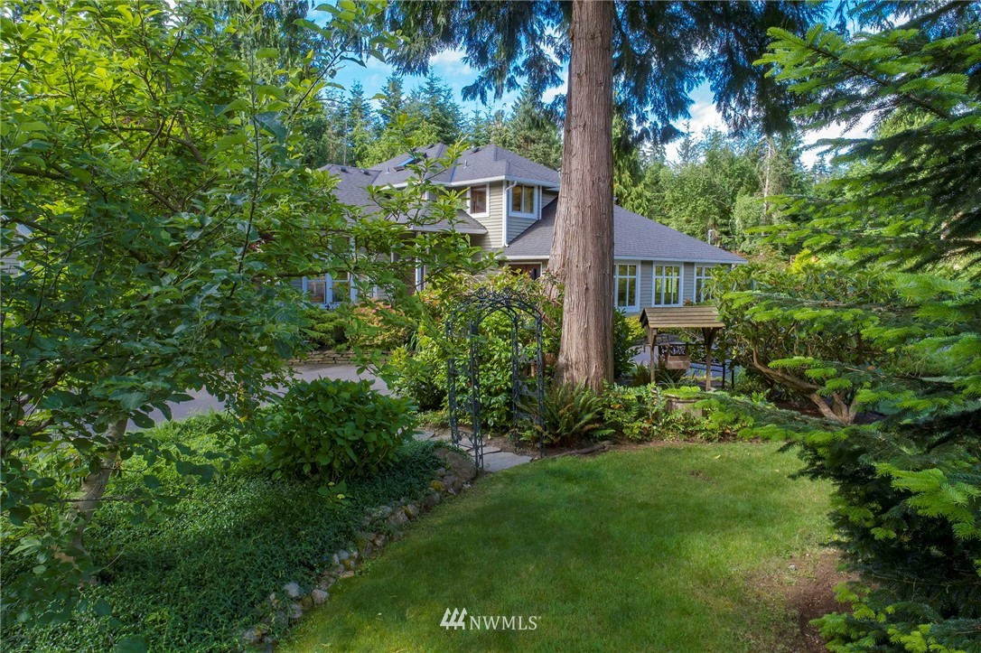 4826 200th Street Southeast Bothell, WA 98012 - Photo 34 of 40 a view of a garden with plants and large trees
