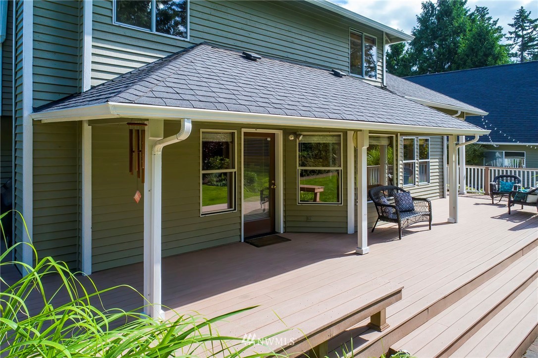4826 200th Street Southeast Bothell, WA 98012 - Photo 40 of 40 a patio with a table and chairs under an umbrella