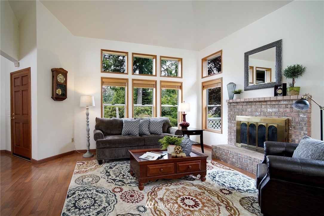 4826 200th Street Southeast Bothell, WA 98012 - Photo 9 of 40 a living room with furniture and a fireplace