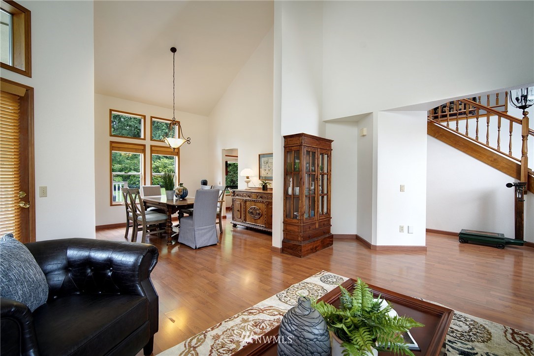 4826 200th Street Southeast Bothell, WA 98012 - Photo 10 of 40 a living room with furniture window and a chandelier