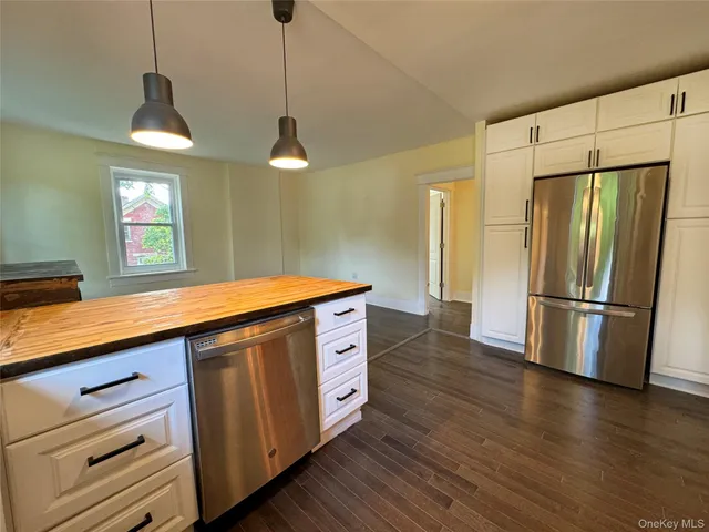 a kitchen with stainless steel appliances granite countertop a refrigerator a sink and a stove