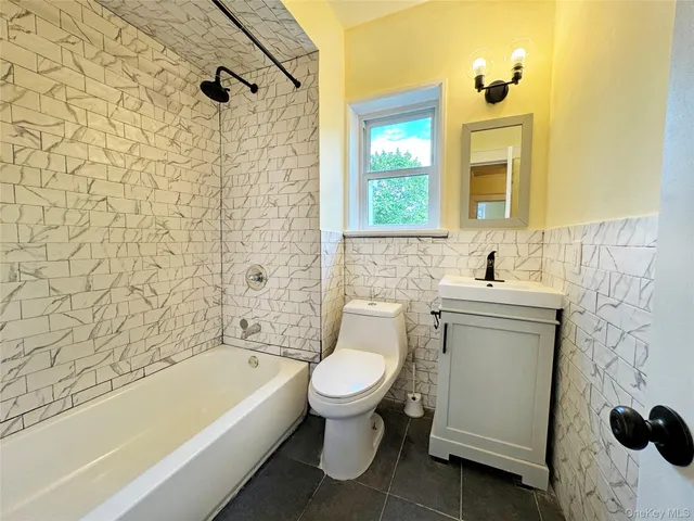 a bathroom with a sink a toilet and a bathtub