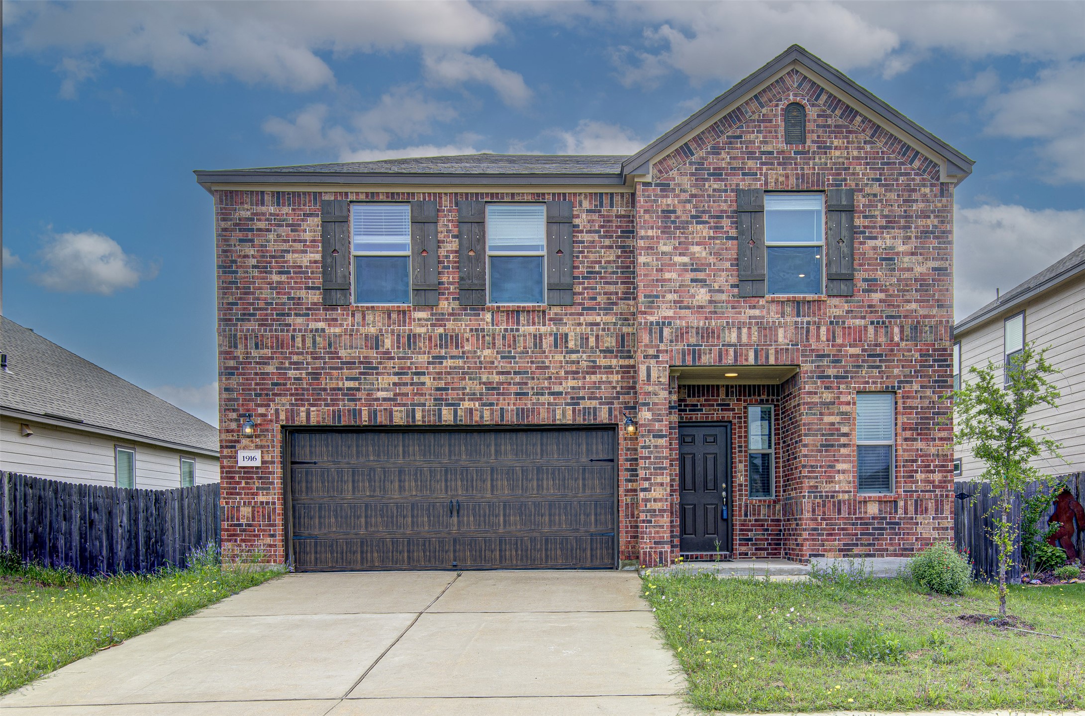 a front view of a house with yard