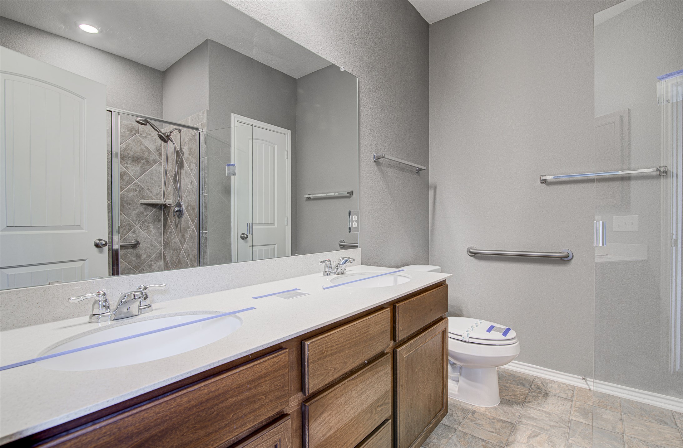 1916 Dragonfly Loop Bastrop, TX 78602 - Photo 14 of 33 a bathroom with a granite countertop sink a toilet and a mirror