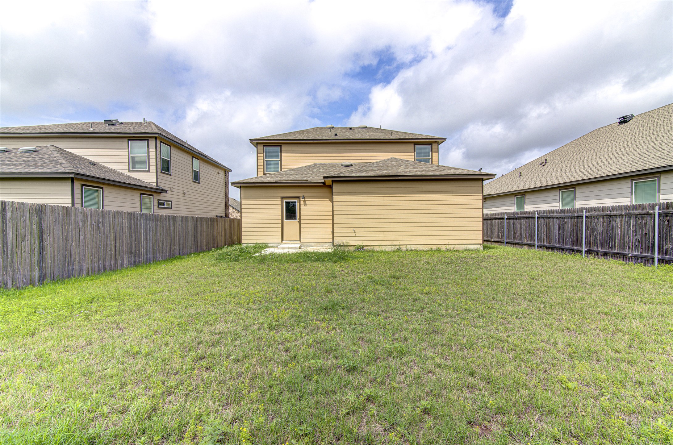 1916 Dragonfly Loop Bastrop, TX 78602 - Photo 30 of 33 a front view of a house with a garden