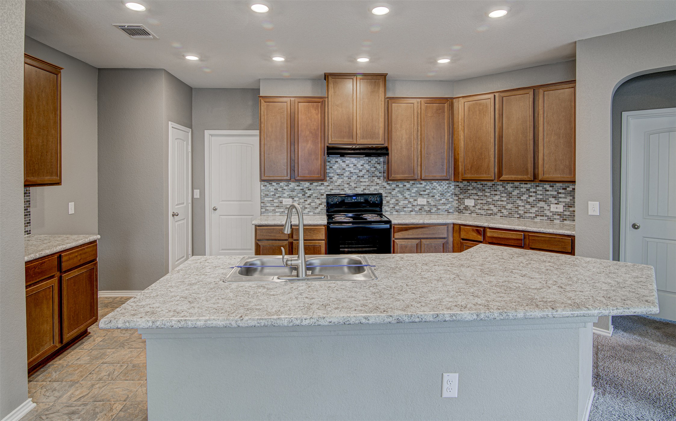 1916 Dragonfly Loop Bastrop, TX 78602 - Photo 3 of 33 a kitchen with kitchen island granite countertop counter top space cabinets and stainless steel appliances