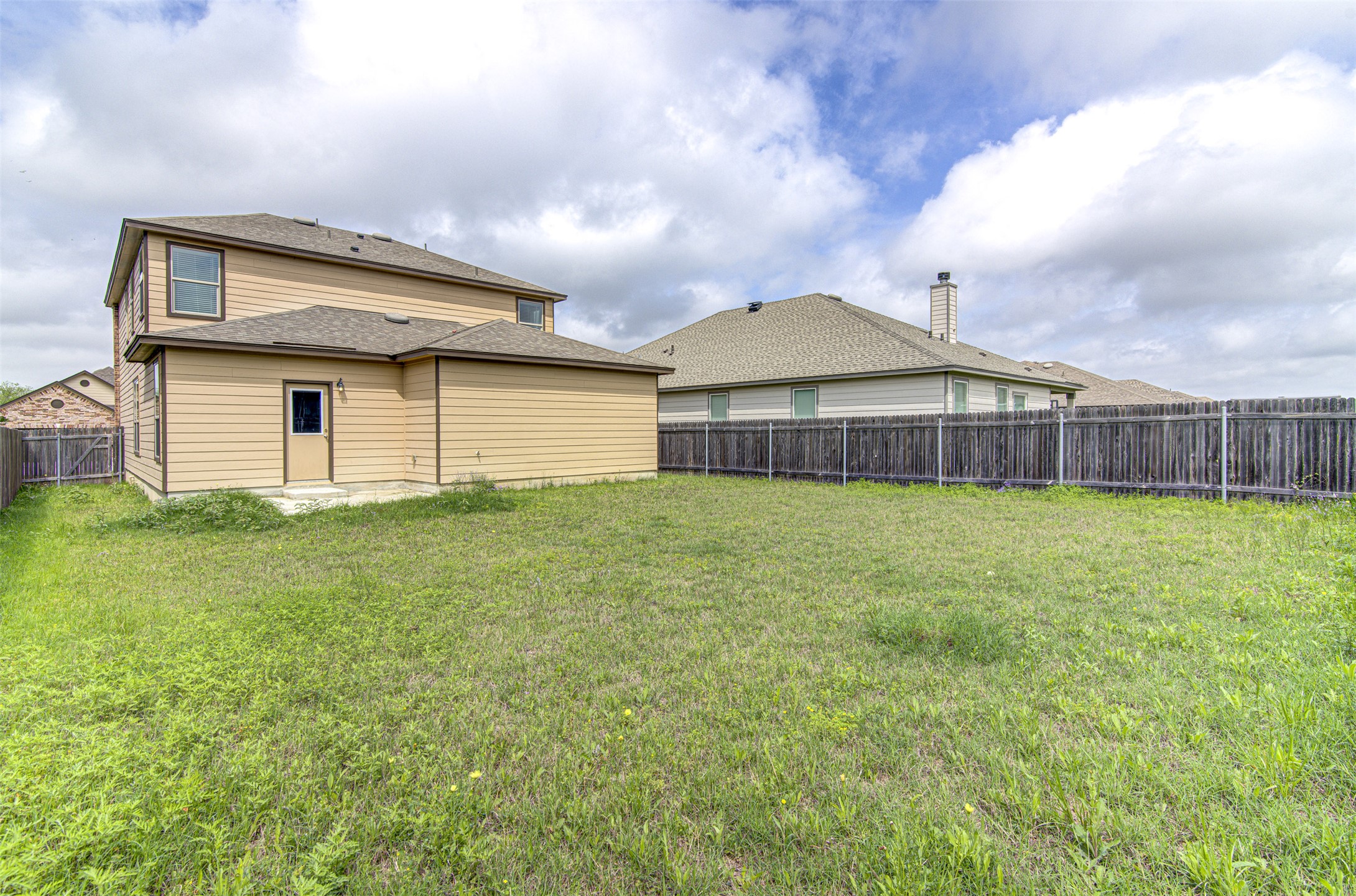 1916 Dragonfly Loop Bastrop, TX 78602 - Photo 31 of 33 a front view of a house with a garden