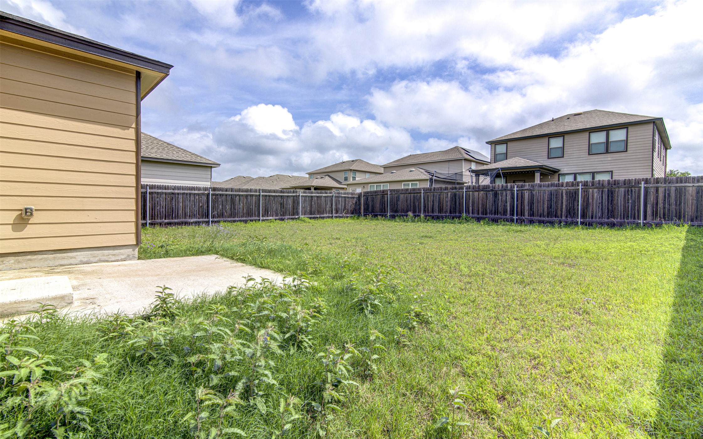 1916 Dragonfly Loop Bastrop, TX 78602 - Photo 33 of 33 a view of a house with a yard and wooden fence